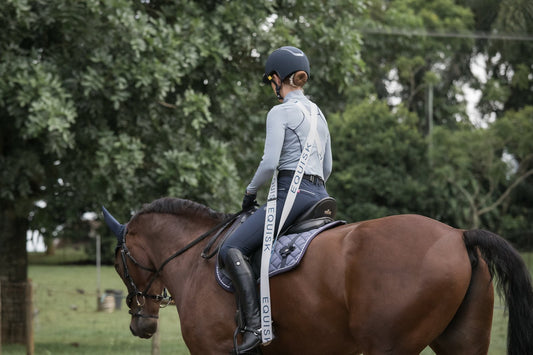 Female equestrian riding a horse in dressage position