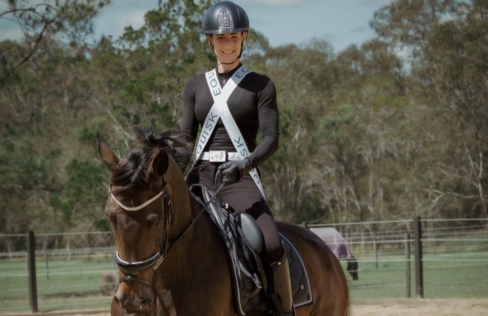 Female rider riding a horse during training