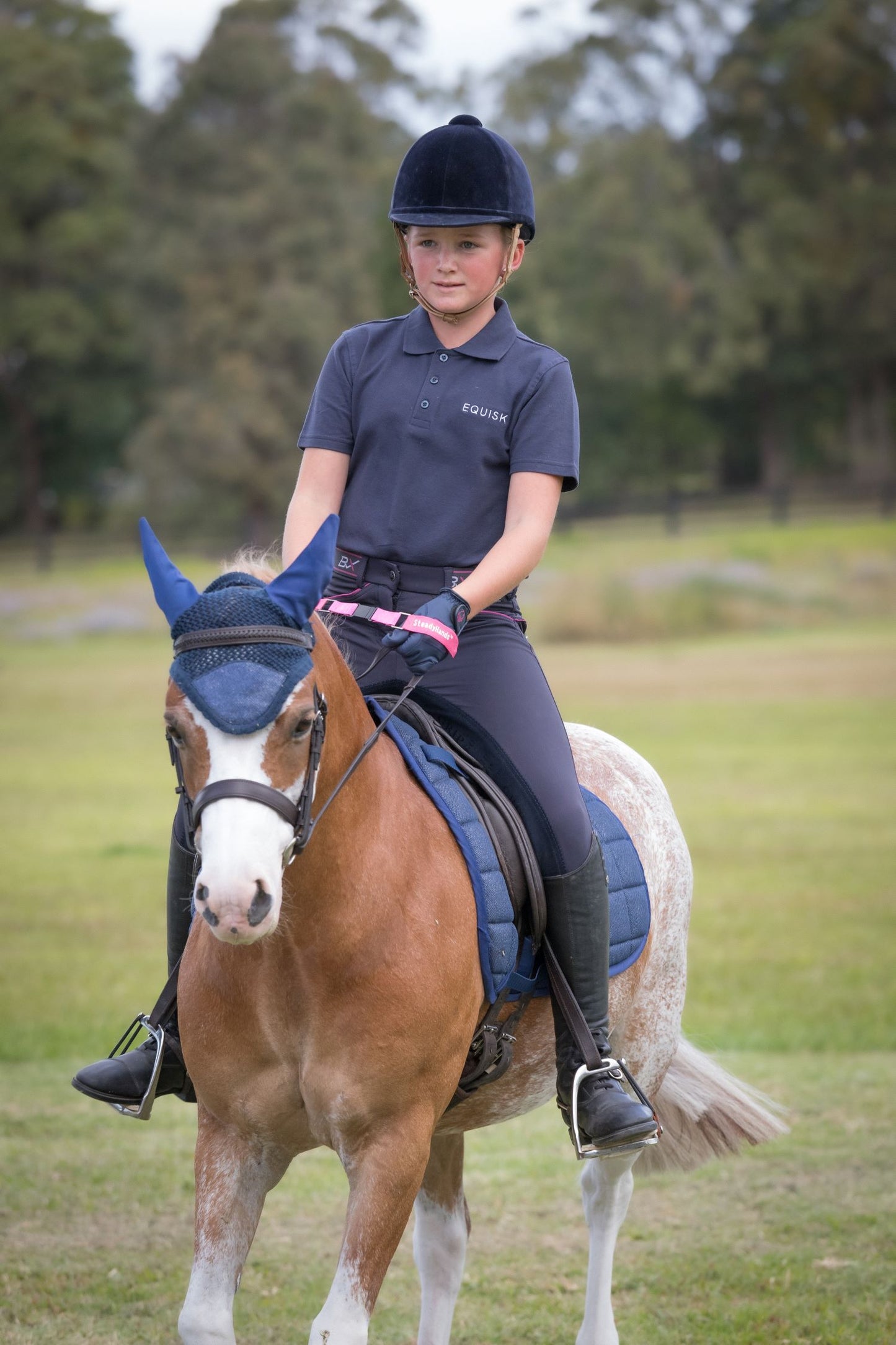 junior rider on coloured pony riding with steadyhands riding gloves 